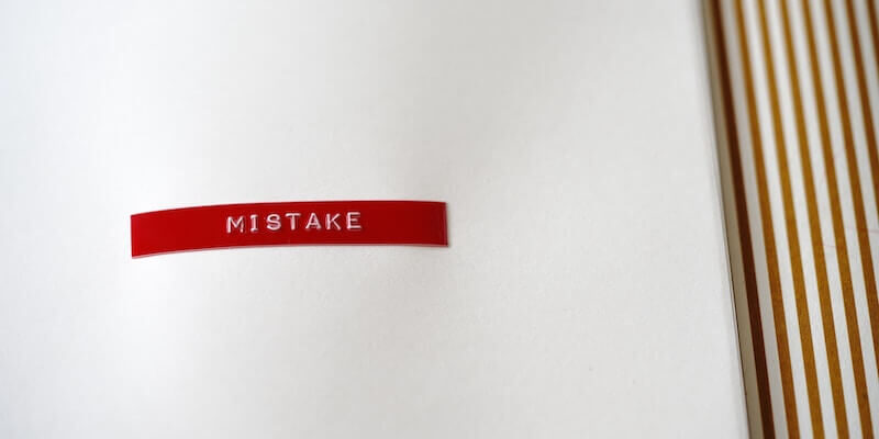 white-emboss-word-mistake-on-red-label